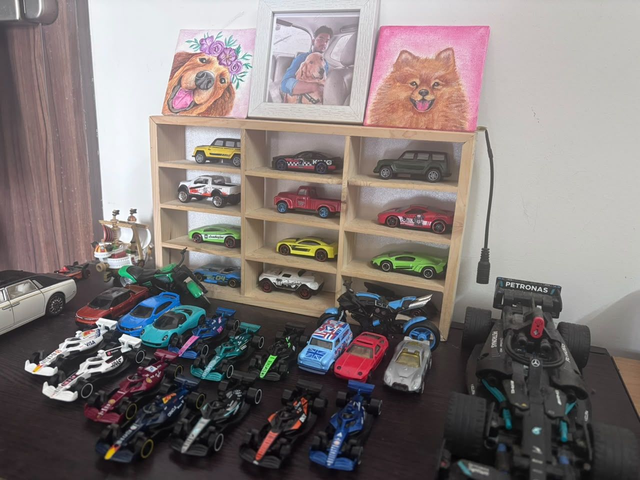 A shelf of model cars and F1 models